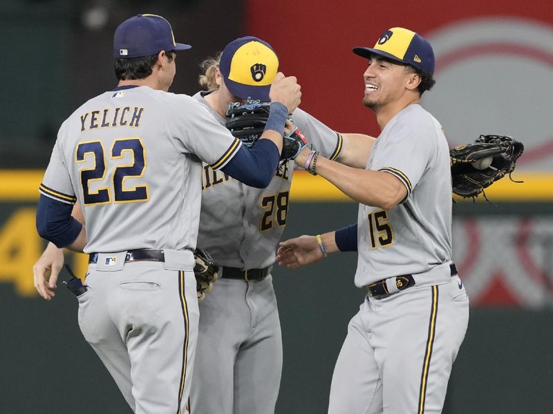 Aug 20, 2023; Arlington, Texas, USA; Milwaukee Brewers left fielder Christian Yelich (22), center fielder Joey Wiemer (28) and Milwaukee Brewers right fielder Tyrone Taylor (15) celebrate their teams 6-2 win over the Texas Rangers during the ninth inning at Globe Life Field. Mandatory Credit: Jim Cowsert-USA TODAY Sports