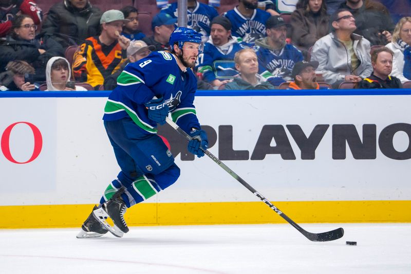 Jan 3, 2025; Vancouver, British Columbia, CAN; Vancouver Canucks forward J.T. Miller (9) handles the puck against the Nashville Predators in the third period at Rogers Arena. Mandatory Credit: Bob Frid-Imagn Images