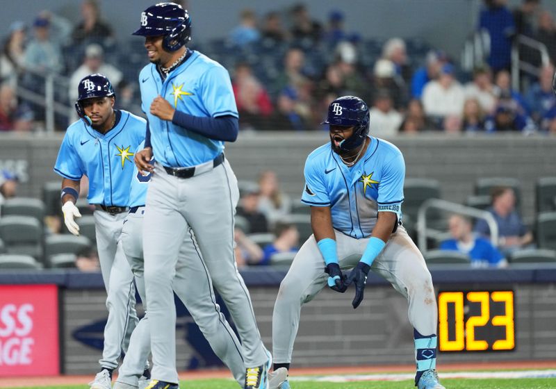 May 13, 2025; Toronto, Ontario, CAN; Tampa Bay Rays third baseman Junior Caminero (13) celebrates hitting a grand slam home run against the Toronto Blue Jays during the ninth inning at Rogers Centre. Mandatory Credit: Nick Turchiaro-Imagn Images