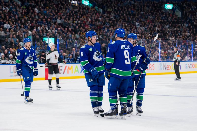 Jan 18, 2024; Vancouver, British Columbia, CAN; Vancouver Canucks forward Elias Pettersson (40) and forward Brock Boeser (6) and forward J.T. Miller (9) and defenseman Quinn Hughes (43) during a stop in play against the Arizona Coyotes in the third period at Rogers Arena. Vancouver won 2-1. Mandatory Credit: Bob Frid-USA TODAY Sports