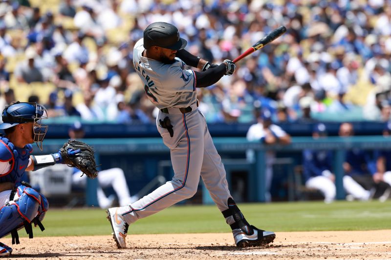 May 8, 2024; Los Angeles, California, USA;  Miami Marlins designated hitter Bryan De La Cruz (14) hits a single during the sixth inning against the Los Angeles Dodgers at Dodger Stadium. Mandatory Credit: Kiyoshi Mio-USA TODAY Sports