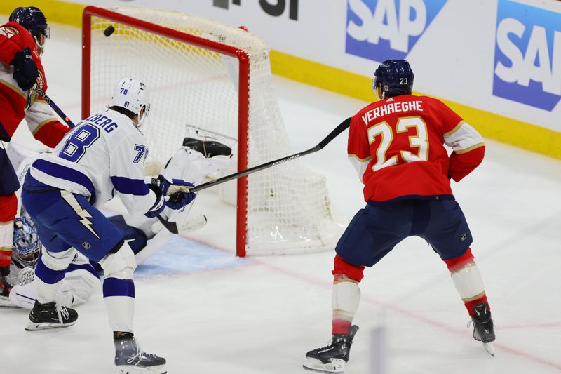 Apr 23, 2024; Sunrise, Florida, USA; Florida Panthers center Carter Verhaeghe (23) scores against Tampa Bay Lightning goaltender Andrei Vasilevskiy (88) during overtime in game two of the first round of the 2024 Stanley Cup Playoffs at Amerant Bank Arena. Mandatory Credit: Sam Navarro-USA TODAY Sports