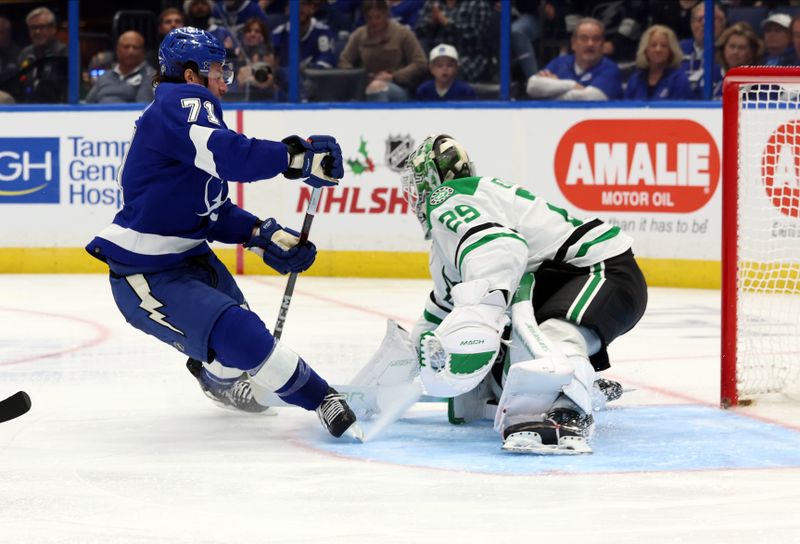 Dec 4, 2023; Tampa, Florida, USA; Tampa Bay Lightning center Anthony Cirelli (71) shoots as Dallas Stars goaltender Jake Oettinger (29) defends during the third period at Amalie Arena. Mandatory Credit: Kim Klement Neitzel-USA TODAY Sports