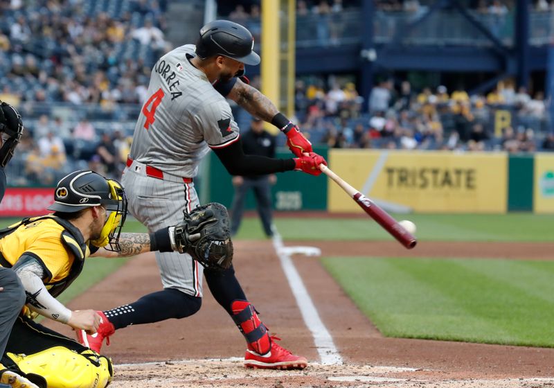 Jun 7, 2024; Pittsburgh, Pennsylvania, USA;  Minnesota Twins shortstop Carlos Correa (4) hits a single against the Pittsburgh Pirates during the fifth inning at PNC Park. Mandatory Credit: Charles LeClaire-USA TODAY Sports