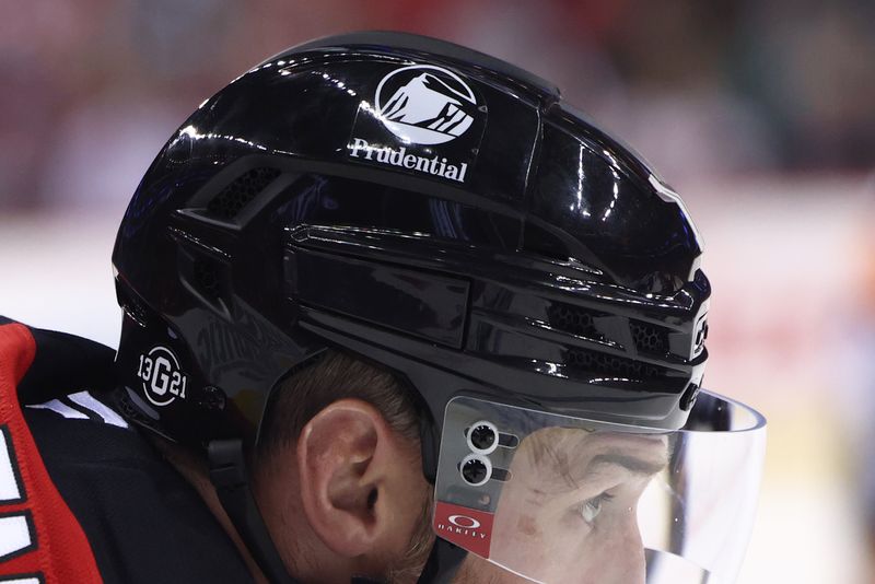 Oct 10, 2024; Newark, New Jersey, USA; A sticker on the helmet of New Jersey Devils right wing Stefan Noesen (11) in remembrance of Johnny and Matthew Gaudreau during the second period of their game against the Toronto Maple Leafs at Prudential Center. Mandatory Credit: Ed Mulholland-Imagn Images