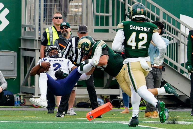 Nov 18, 2023; Fort Collins, Colorado, USA;  Nevada Wolf Pack quarterback Brendon Lewis (2) flies over the pylon for a touchdown after Colorado State Rams linebacker Chase Wilson (30) hit him at Sonny Lubick Field at Canvas Stadium. Mandatory Credit: Michael Madrid-USA TODAY Sports