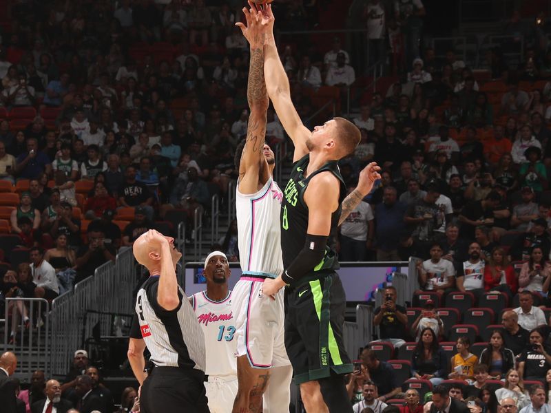 MIAMI, FL - FEBRUARY 10:  Kel'el Ware #7 of the Miami Heat and Kristaps Porzingis #8 of the Boston Celtics go up for the opening tip off on February 10, 2025 at Kaseya Center in Miami, Florida. NOTE TO USER: User expressly acknowledges and agrees that, by downloading and or using this Photograph, user is consenting to the terms and conditions of the Getty Images License Agreement. Mandatory Copyright Notice: Copyright 2025 NBAE (Photo by Issac Baldizon/NBAE via Getty Images)