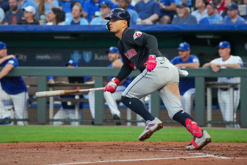 Sep 4, 2024; Kansas City, Missouri, USA; Cleveland Guardians second baseman Andrés Giménez (0) hits a double against the Kansas City Royals in the third inning at Kauffman Stadium. Mandatory Credit: Denny Medley-Imagn Images