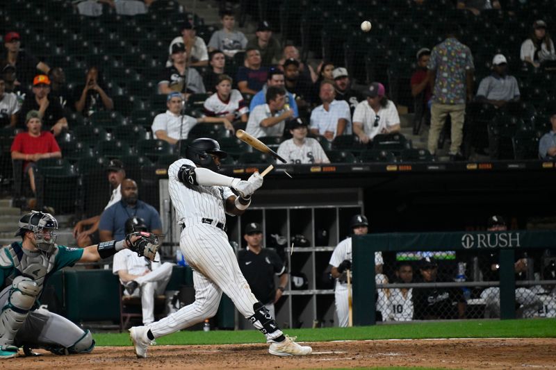 Aug 22, 2023; Chicago, Illinois, USA; Chicago White Sox right fielder Oscar Colas (22) breaks his bat during the ninth inning against the Seattle Mariners at Guaranteed Rate Field. Mandatory Credit: Matt Marton-USA TODAY Sports