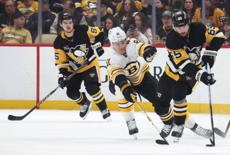 Mar 8, 2026; Pittsburgh, Pennsylvania, USA;  Pittsburgh Penguins defenseman Erik Karlsson (65) handles the puck against Boston Bruins defenseman Nikita Zadorov (91) during the second period at PPG Paints Arena. Mandatory Credit: Charles LeClaire-Imagn Images
