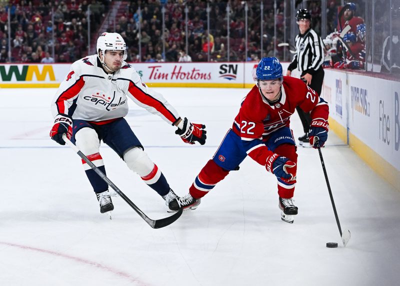 Oct 21, 2023; Montreal, Quebec, CAN; Montreal Canadiens right wing Cole Caufield (22) plays the puck against Washington Capitals defenseman Hardy Haman Aktell (4) during the second period at Bell Centre. Mandatory Credit: David Kirouac-USA TODAY Sports