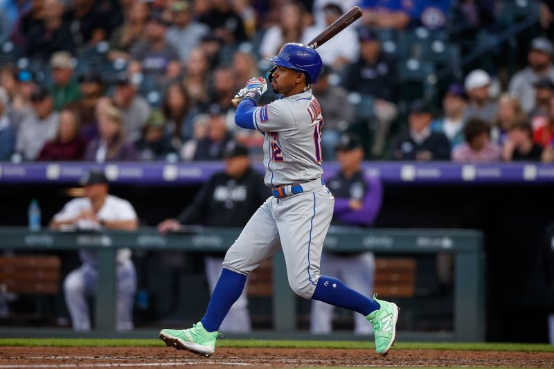 May 26, 2023; Denver, Colorado, USA; New York Mets shortstop Francisco Lindor (12) hits an RBI single in the fifth inning against the Colorado Rockies at Coors Field. Mandatory Credit: Isaiah J. Downing-USA TODAY Sports