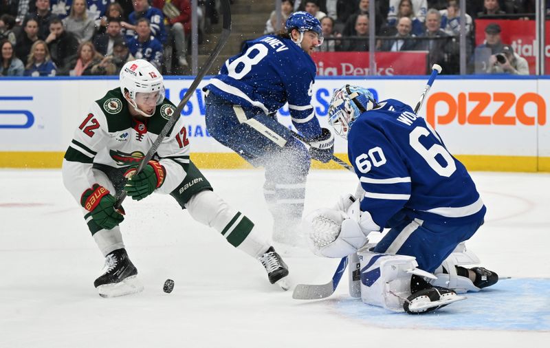 Jan 29, 2025; Toronto, Ontario, CAN;  Toronto Maple Leafs goalie Joseph Woll (60) makes a save on a shot from Minnesota Wild forward Matt Boldy (12) in the second period at Scotiabank Arena. Mandatory Credit: Dan Hamilton-Imagn Images