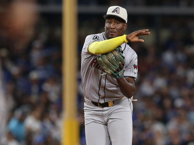 Jul 4, 2024; Los Angeles, California, USA; Arizona Diamondbacks shortstop Geraldo Perdomo (2) throws to first for an out during the eighth inning against the Los Angeles Dodgers at Dodger Stadium. Mandatory Credit: Jason Parkhurst-USA TODAY Sports