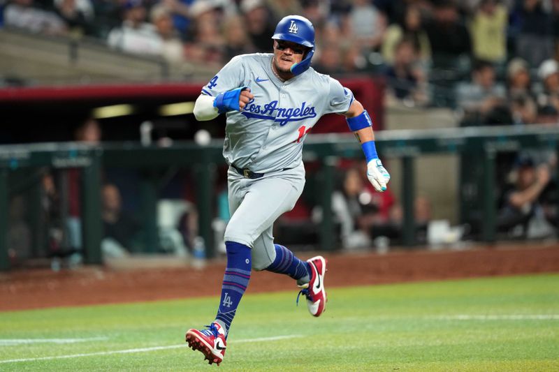 Apr 29, 2024; Phoenix, Arizona, USA; Los Angeles Dodgers shortstop Miguel Rojas (11) rounds third base and scores a run against the Arizona Diamondbacks during the eighth inning at Chase Field. Mandatory Credit: Joe Camporeale-USA TODAY Sports