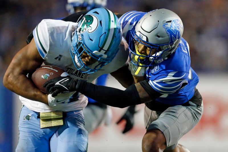 Oct 13, 2023; Memphis, Tennessee, USA; Tulane Green Wave running back Makhi Hughes (21) runs the ball as Memphis Tigers defensive back Cameron Smith (29) makes the tackle during the second half at Simmons Bank Liberty Stadium. Mandatory Credit: Petre Thomas-USA TODAY Sports