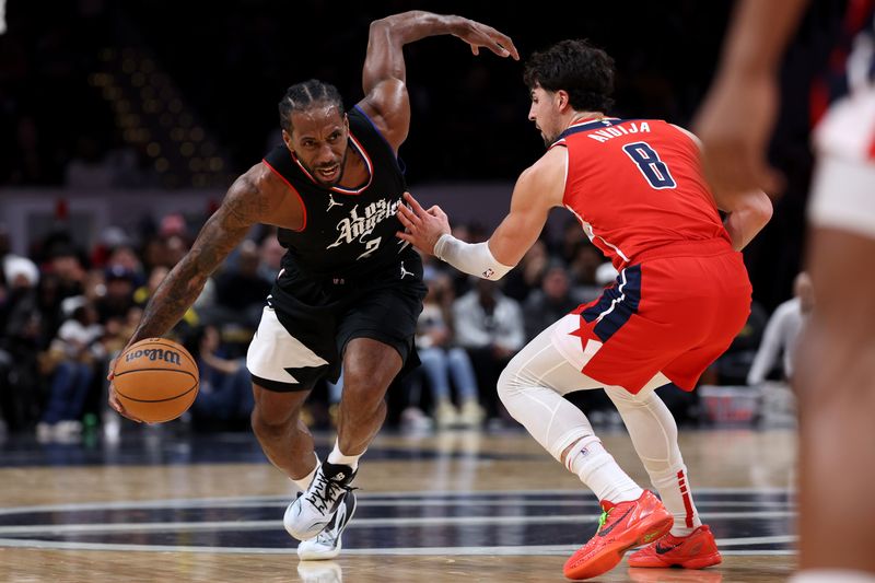 WASHINGTON, DC - JANUARY 31: Kawhi Leonard #2 of the LA Clippers dribbles past Deni Avdija #8 of the Washington Wizards during second half at Capital One Arena on January 31, 2024 in Washington, DC. NOTE TO USER: User expressly acknowledges and agrees that, by downloading and or using this photograph, User is consenting to the terms and conditions of the Getty Images License Agreement. (Photo by Patrick Smith/Getty Images)