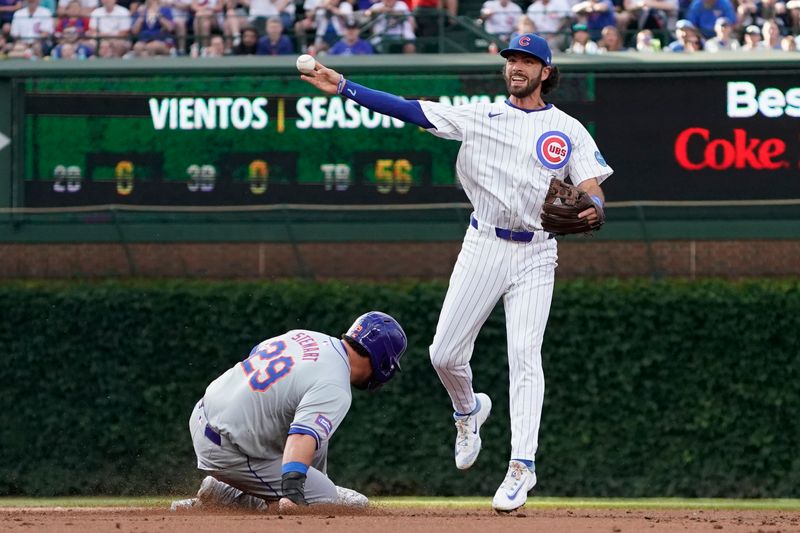 Jun 23, 2024; Chicago, Illinois, USA; Chicago Cubs shortstop Dansby Swanson (7) forces out New York Mets outfielder DJ Stewart (29) at second base then throws to first base to complete a double play during the second inning at Wrigley Field. Mandatory Credit: David Banks-USA TODAY Sports