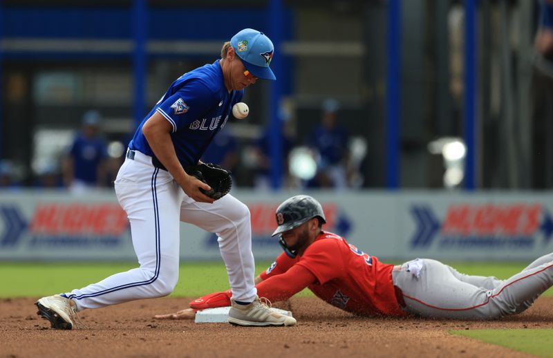 Mar 2, 2026; Dunedin, Florida, USA;  Boston Red Sox center fielder Allan Castro (94) slides safe into second base as Toronto Blue Jays shortstop Josh Kasevich (86) attempted to tag him out during the second inning at TD Ballpark. Mandatory Credit: Kim Klement Neitzel-Imagn Images