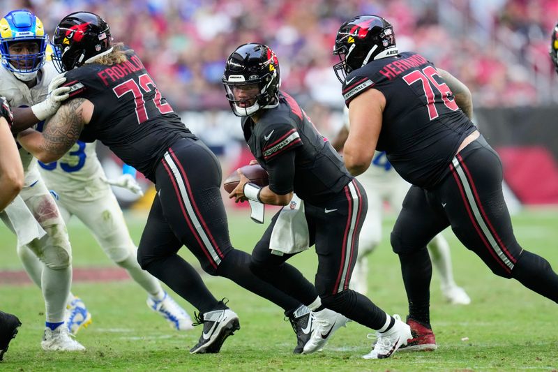 Arizona Cardinals quarterback Kyler Murray, center, gets blocking help from Cardinals guards Hjalte Froholdt (72) and Will Hernandez (76) during the second half of an NFL football game against the Los Angeles Rams Sunday, Nov. 26, 2023, in Glendale, Ariz. The Rams won 37-14. (AP Photo/Ross D. Franklin)