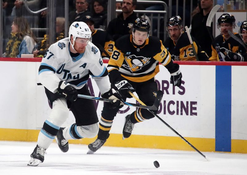 Nov 23, 2024; Pittsburgh, Pennsylvania, USA;  Utah Hockey Club left wing Lawson Crouse (67) chases the puck ahead of Pittsburgh Penguins defenseman Owen Pickering (38) during the second period at PPG Paints Arena. Mandatory Credit: Charles LeClaire-Imagn Images