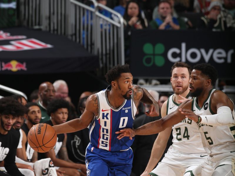 MILWAUKEE, WI - JANUARY 14: Malik Monk #0 of the Sacramento Kings dribbles the ball during the game against the Milwaukee Bucks on January 14, 2024 at the Fiserv Forum Center in Milwaukee, Wisconsin. NOTE TO USER: User expressly acknowledges and agrees that, by downloading and or using this Photograph, user is consenting to the terms and conditions of the Getty Images License Agreement. Mandatory Copyright Notice: Copyright 2024 NBAE (Photo by Gary Dineen/NBAE via Getty Images).