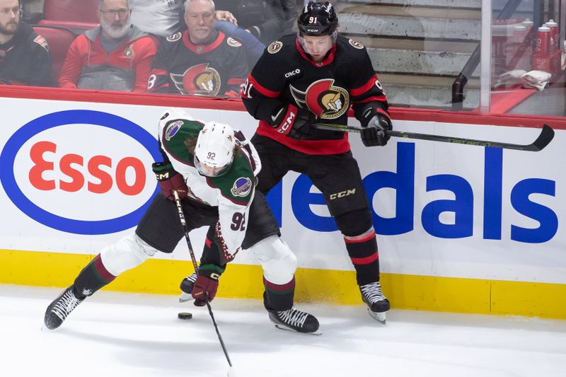 Mar 1, 2024; Ottawa, Ontario, CAN; Arizona Coyotes cnter Logan Cooley (92) battles with Ottawa Senators defenseman Vladimir Tarasenko (91) in the third period at the Canadian Tire Centre. Mandatory Credit: Marc DesRosiers-USA TODAY Sports