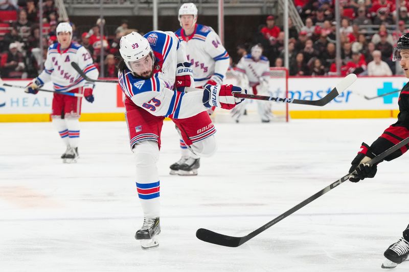 Nov 15, 2025; Raleigh, North Carolina, USA; New York Rangers center Mika Zibanejad (93) gets the shot away against the Carolina Hurricanes during the second period at Lenovo Center. Mandatory Credit: James Guillory-Imagn Images