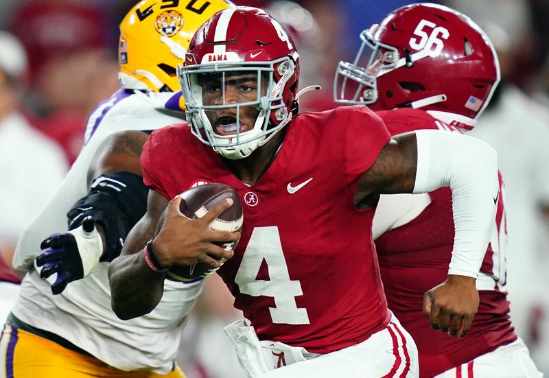 Nov 4, 2023; Tuscaloosa, Alabama, USA; Alabama Crimson Tide quarterback Jalen Milroe (4) scrambles up the field against the LSU Tigers during the second quarter at Bryant-Denny Stadium. Mandatory Credit: John David Mercer-USA TODAY Sports