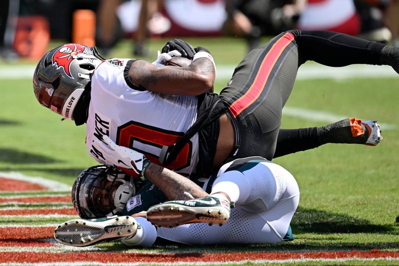 Tampa Bay Buccaneers' Trey Palmer, top, scores a touchdown over Philadelphia Eagles' Darius Slay Jr. during the first half of an NFL football game, Sunday, Sept. 29, 2024, in Tampa, Fla. (AP Photo/Jason Behnken)