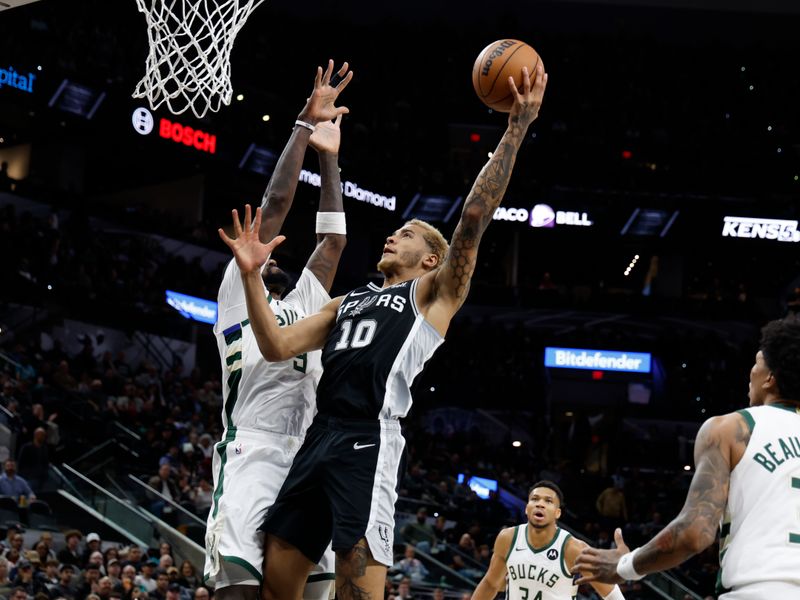 SAN ANTONIO, TX - JANUARY  04:  Jeremy Sochan #10 of the San Antonio Spurs drives against Bobby Portis #9 of the Milwaukee Bucks in the first half at Frost Bank Center on January  04, 2024 in San Antonio, Texas. NOTE TO USER: User expressly acknowledges and agrees that, by downloading and or using this photograph, User is consenting to terms and conditions of the Getty Images License Agreement. (Photo by Ronald Cortes/Getty Images)