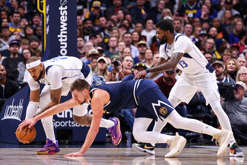 DENVER, COLORADO - NOVEMBER 10: Daniel Gafford #21 of the Dallas Mavericks and Nikola Jokic #15 of the Denver Nuggets battle for a loose ball in the first half at Ball Arena on November 10, 2024 in Denver, Colorado. NOTE TO USER: User expressly acknowledges and agrees that, by downloading and or using this photograph, user is consenting to the terms and conditions of the Getty Images License Agreement. (Photo by Tyler Schank/Clarkson Creative/Getty Images)