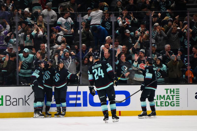 Dec 12, 2023; Seattle, Washington, USA; The Seattle Kraken celebrate after a goal scored by center Alex Wennberg (21) during the third period against the Florida Panthers at Climate Pledge Arena. Mandatory Credit: Steven Bisig-USA TODAY Sports