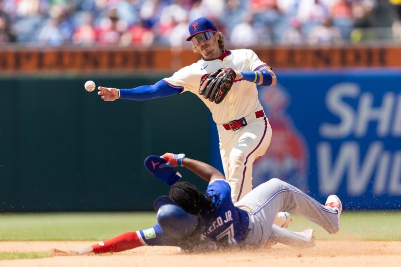 May 8, 2024; Philadelphia, Pennsylvania, USA; Philadelphia Phillies second base Bryson Stott (5) tags out Toronto Blue Jays first base Vladimir Guerrero Jr. (27) but unable to turn a double play during the sixth inning at Citizens Bank Park. Mandatory Credit: Bill Streicher-USA TODAY Sports