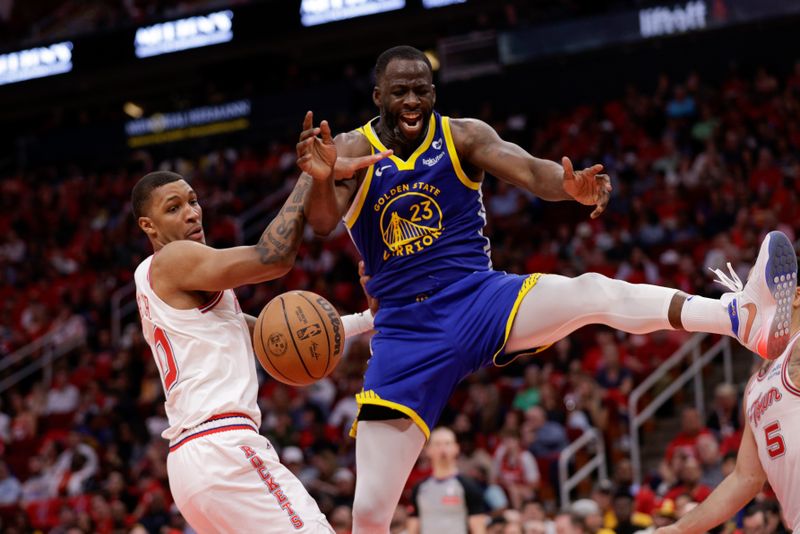 HOUSTON, TEXAS - APRIL 04: Jabari Smith Jr. #10 of the Houston Rockets defends Draymond Green #23 of the Golden State Warriors in the second half at Toyota Center on April 04, 2024 in Houston, Texas.  NOTE TO USER: User expressly acknowledges and agrees that, by downloading and or using this photograph, User is consenting to the terms and conditions of the Getty Images License Agreement. (Photo by Tim Warner/Getty Images)