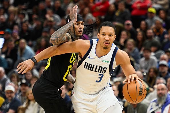 SALT LAKE CITY, UTAH - JANUARY 01: Grant Williams #3 of the Dallas Mavericks drives past Jordan Clarkson #00 of the Utah Jazz during the second half of a game at Delta Center on January 01, 2024 in Salt Lake City, Utah. NOTE TO USER: User expressly acknowledges and agrees that, by downloading and or using this photograph, User is consenting to the terms and conditions of the Getty Images License Agreement. (Photo by Alex Goodlett/Getty Images)