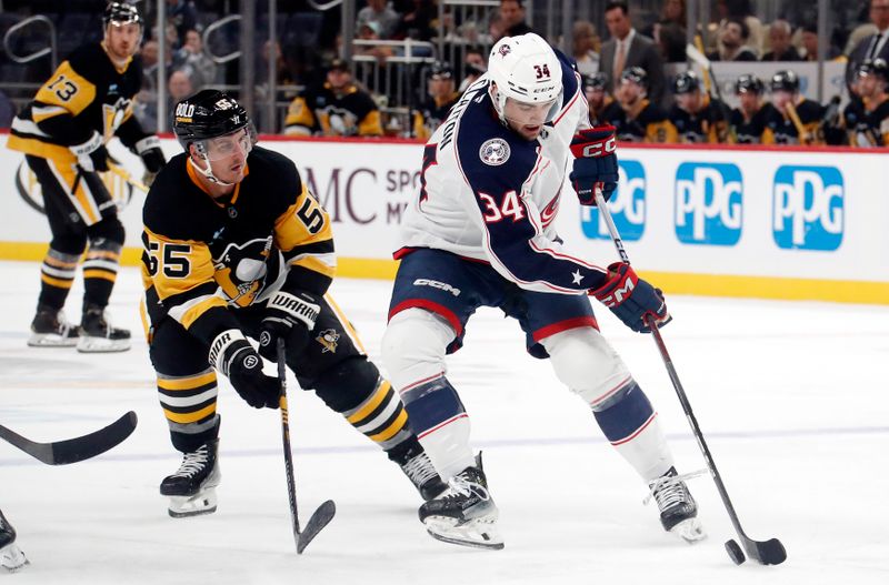 Oct 4, 2024; Pittsburgh, Pennsylvania, USA;  Columbus Blue Jackets defenseman Cole Clayon (34) handles the puck against Pittsburgh Penguins center Noel Acciari (55) during the third period at PPG Paints Arena. Mandatory Credit: Charles LeClaire-Imagn Images