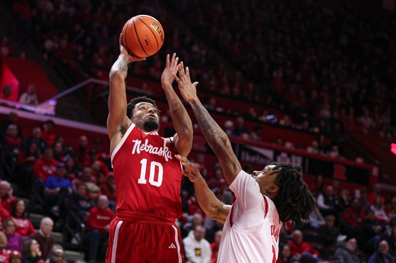 Feb 7, 2026; Piscataway, New Jersey, USA; Nebraska Cornhuskers guard Jamarques Lawrence (10) shoots the ball against Rutgers Scarlet Knights guard Jamichael Davis (1) during the first half at Jersey Mike's Arena. Mandatory Credit: Vincent Carchietta-Imagn Images