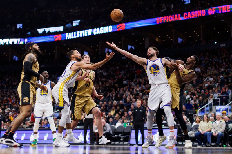 TORONTO, CANADA - MARCH 1: Stephen Curry #30 and Klay Thompson #11 of the Golden State Warriors reach for a loose ball against RJ Barrett #9, Kelly Olynyk #41 and Gary Trent Jr. #33 of the Toronto Raptors  in the second half of their NBA game  at Scotiabank Arena on March 1, 2024 in Toronto, Canada.  NOTE TO USER: User expressly acknowledges and agrees that, by downloading and or using this photograph, User is consenting to the terms and conditions of the Getty Images License Agreement. (Photo by Cole Burston/Getty Images)