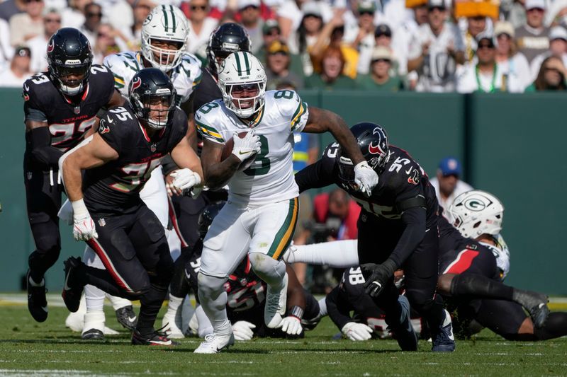 Green Bay Packers running back Josh Jacobs (8) runs for a first down during the first half of an NFL football game against the Houston Texans, Sunday, Oct. 20, 2024, in Green Bay, Wis. (AP Photo/Morry Gash)