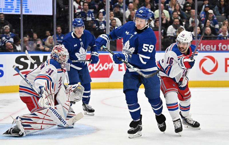 Mar. 2, 2024; Toronto, Ontario, CAN;  Toronto Maple Leafs forward Tyler Bertuzzi (59) deflects the puck as New York Rangers forward Vincent Trochek (16) defends in front of goalie Igor Shesterkin (31) in the first period at Scotiabank Arena. Mandatory Credit: Dan Hamilton-USA TODAY Sports