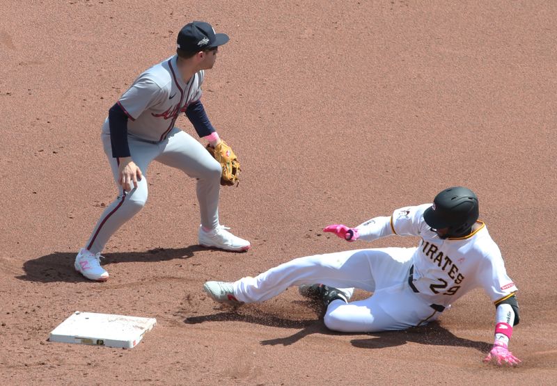 May 11, 2025; Pittsburgh, Pennsylvania, USA; Pittsburgh Pirates outfielder Alexander Canario (29) slides into second base with a double as Atlanta Braves shortstop Nick Allen (2) waits for a late throw during the fourth inning  at PNC Park. Mandatory Credit: Charles LeClaire-Imagn Images