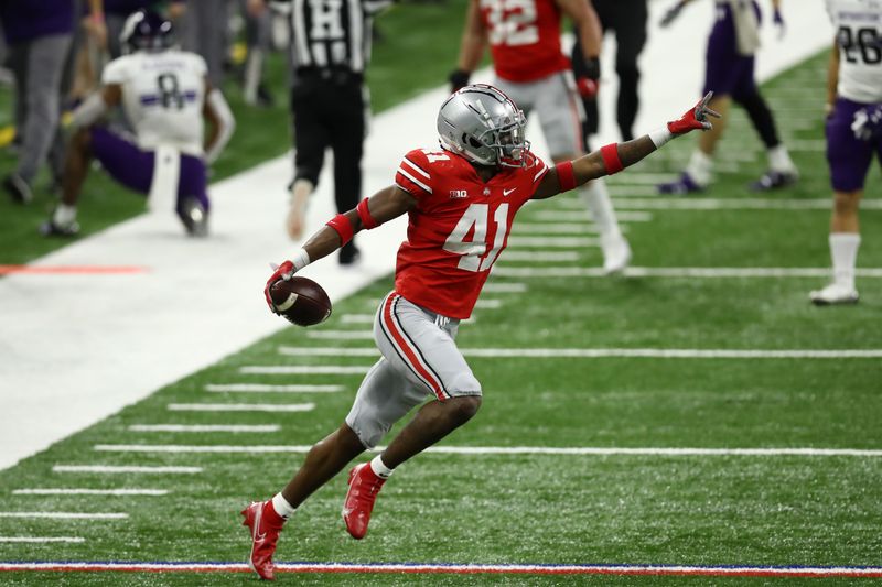 Dec 19, 2020; Indianapolis, Indiana, USA; Ohio State Buckeyes safety Josh Proctor (41) reacts after intercepting a pass against the Northwestern Wildcats during the second half at Lucas Oil Stadium. Mandatory Credit: Aaron Doster-USA TODAY Sports