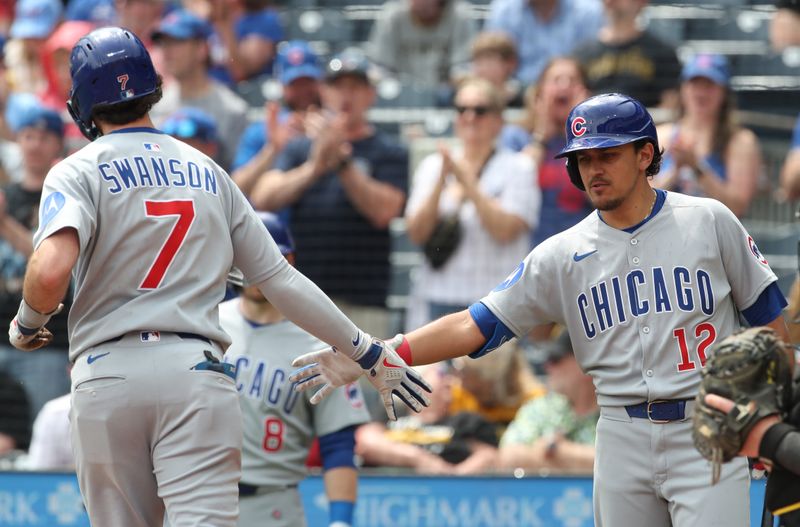 May 1, 2025; Pittsburgh, Pennsylvania, USA; Chicago Cubs third baseman Nicky Lopez (12) greets shortstop Dansby Swanson (7) crossing home plate on a solo home run against the Pittsburgh Pirates during the fifth inning at PNC Park. Mandatory Credit: Charles LeClaire-Imagn Images