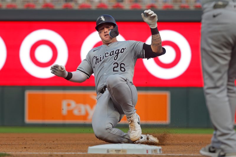 Aug 3, 2024; Minneapolis, Minnesota, USA; Chicago White Sox catcher Korey Lee (26) slides into third base with an RBI triple against the Minnesota Twins in the fifth inning at Target Field. Mandatory Credit: Bruce Kluckhohn-USA TODAY Sports