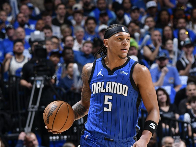 ORLANDO, FL - APRIL 27: Paolo Banchero #5 of the Orlando Magic dribbles the ball during the game against the Cleveland Cavaliers during Round 1 Game 4 of the 2024 NBA Playoffs on April 27, 2024 at the Kia Center in Orlando, Florida. NOTE TO USER: User expressly acknowledges and agrees that, by downloading and or using this photograph, User is consenting to the terms and conditions of the Getty Images License Agreement. Mandatory Copyright Notice: Copyright 2024 NBAE (Photo by Fernando Medina/NBAE via Getty Images)