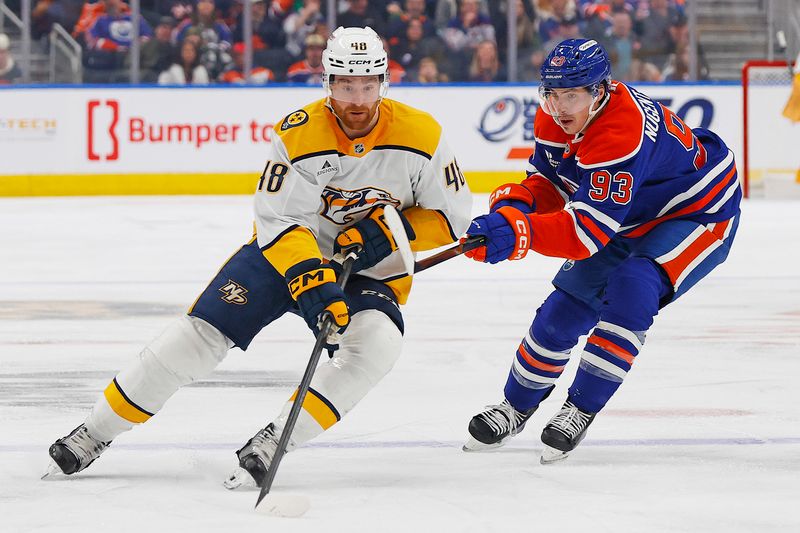 Jan 6, 2026; Edmonton, Alberta, CAN; Nashville Predators defensemen Nick Perbix (48) protects the puck from Edmonton Oilers forward Ryan Nugent-Hopkins (93) during the second period at Rogers Place. Mandatory Credit: Perry Nelson-Imagn Images