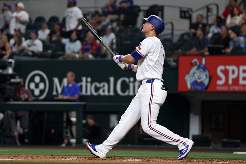 Aug 19, 2024; Arlington, Texas, USA; Texas Rangers shortstop Corey Seager (5) hits a three-run home run against the Pittsburgh Pirates in the third inning at Globe Life Field. Mandatory Credit: Tim Heitman-USA TODAY Sports