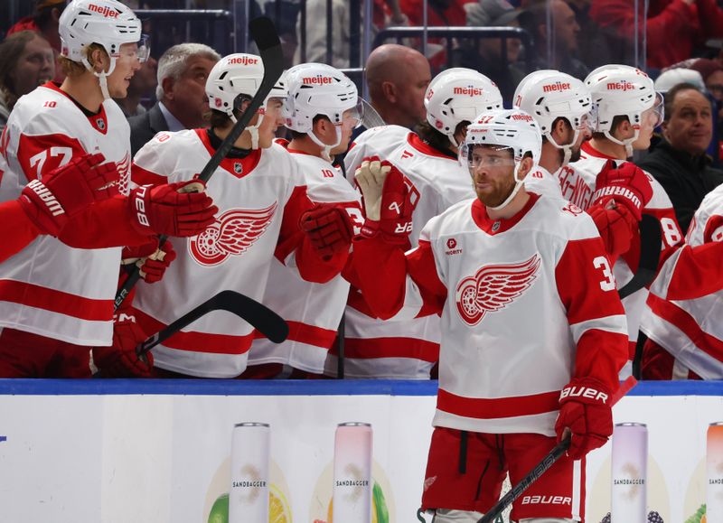 Oct 22, 2025; Buffalo, New York, USA;  Detroit Red Wings left wing J.T. Compher (37) celebrates his goal with teammates during the second period against the Buffalo Sabres at KeyBank Center. Mandatory Credit: Timothy T. Ludwig-Imagn Images