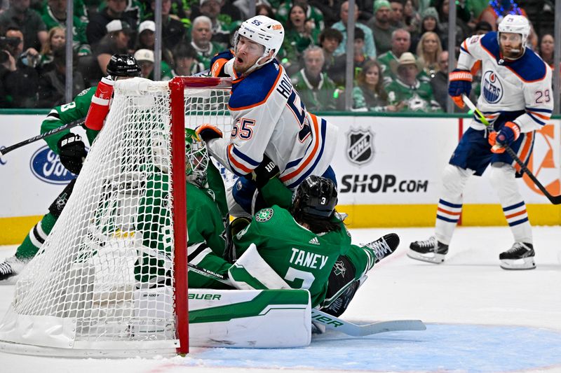 May 25, 2024; Dallas, Texas, USA; Edmonton Oilers left wing Dylan Holloway (55) and Dallas Stars defenseman Chris Tanev (3) crash into goaltender Jake Oettinger (29) during the first period in game two of the Western Conference Final of the 2024 Stanley Cup Playoffs at American Airlines Center. Mandatory Credit: Jerome Miron-USA TODAY Sports
